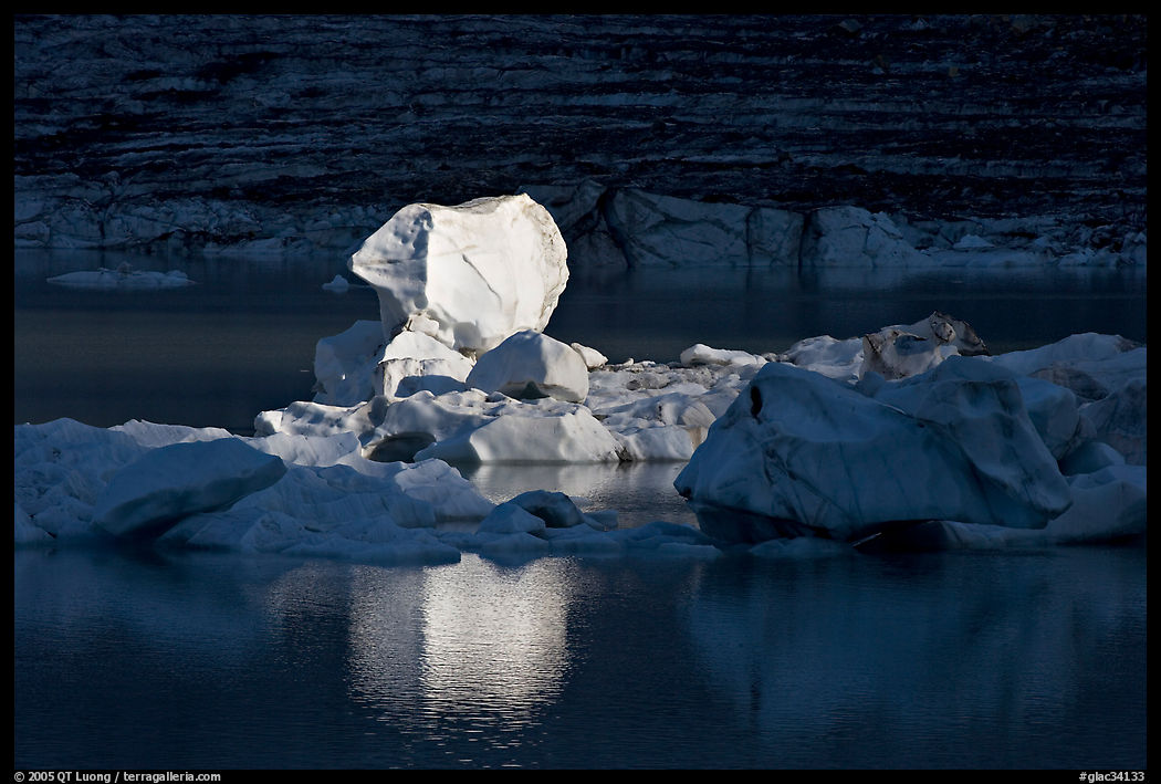 Last light on an iceberg in Upper Grinnell Lake. Glacier National Park, Montana, USA.