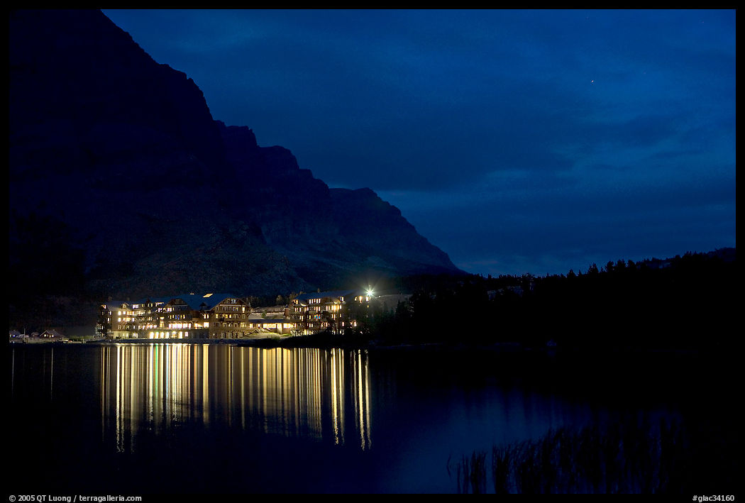 Many Glacier lodge lights reflected in Swiftcurrent Lake at night. Glacier National Park, Montana, USA.