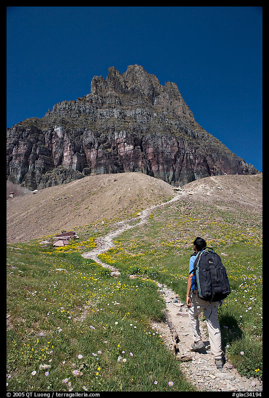 Backpacker and peak near Logan Pass. Glacier National Park, Montana, USA.