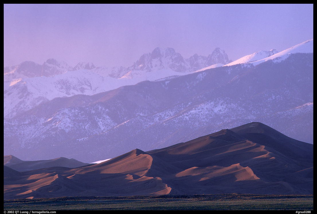 Distant view of the dune field and Sangre de Christo mountains at sunset. Great Sand Dunes National Park, Colorado, USA.