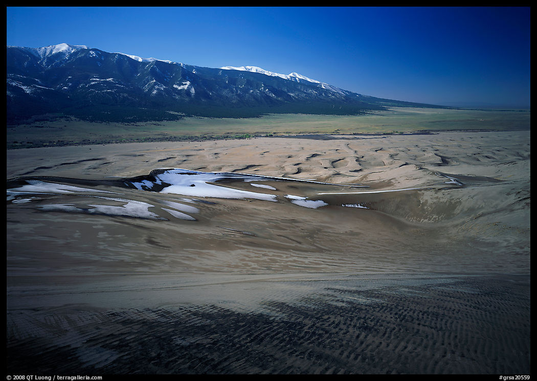 Sand dunes with patches of snow seen from above. Great Sand Dunes National Park, Colorado, USA.