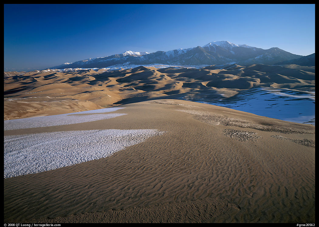 Sand dunes with snow patches and Sangre de Christo range. Great Sand Dunes National Park, Colorado, USA.