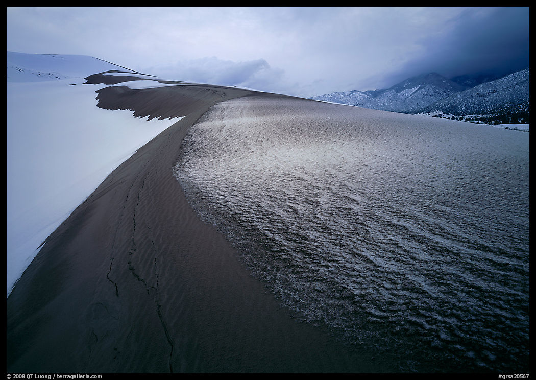 Zig-zag pattern of sand amongst Snow on the dunes. Great Sand Dunes National Park, Colorado, USA.
