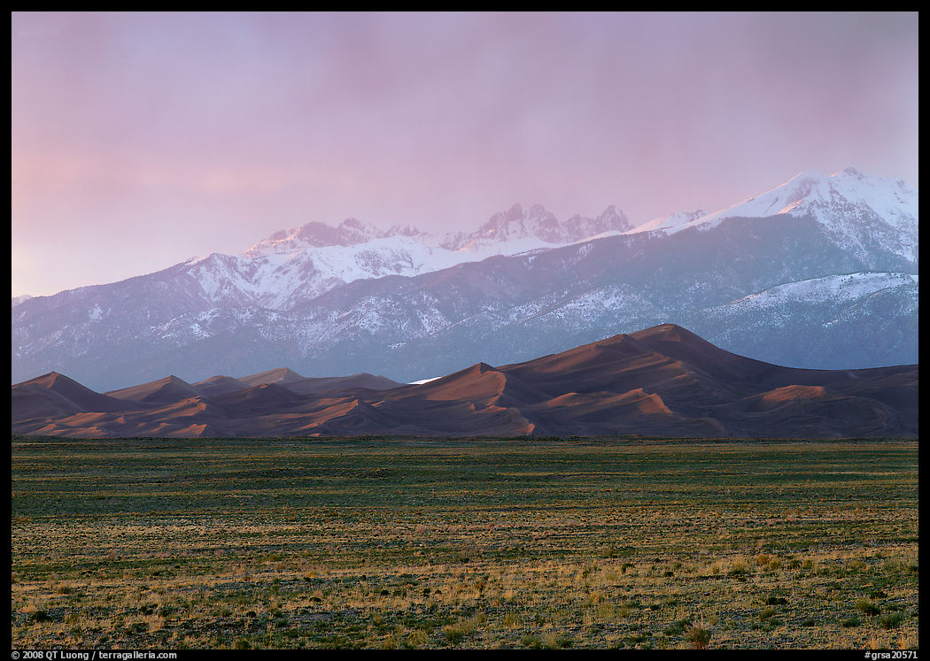 Flats, sand dunes, and snowy Sangre de Christo mountains. Great Sand Dunes National Park, Colorado, USA.