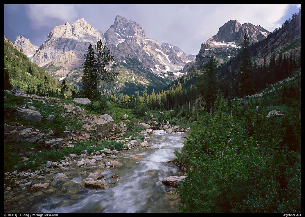Valley, Cascade creek and Teton range with storm light. Grand Teton National Park