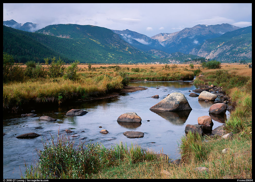 Creek, boulders, and meadow surrounded by mountains, autum. Rocky Mountain National Park, Colorado, USA.