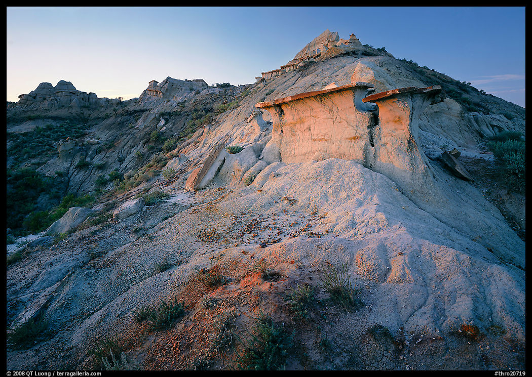 Badlands and caprock formation at sunset, South Unit. Theodore Roosevelt  National Park, North Dakota, USA.