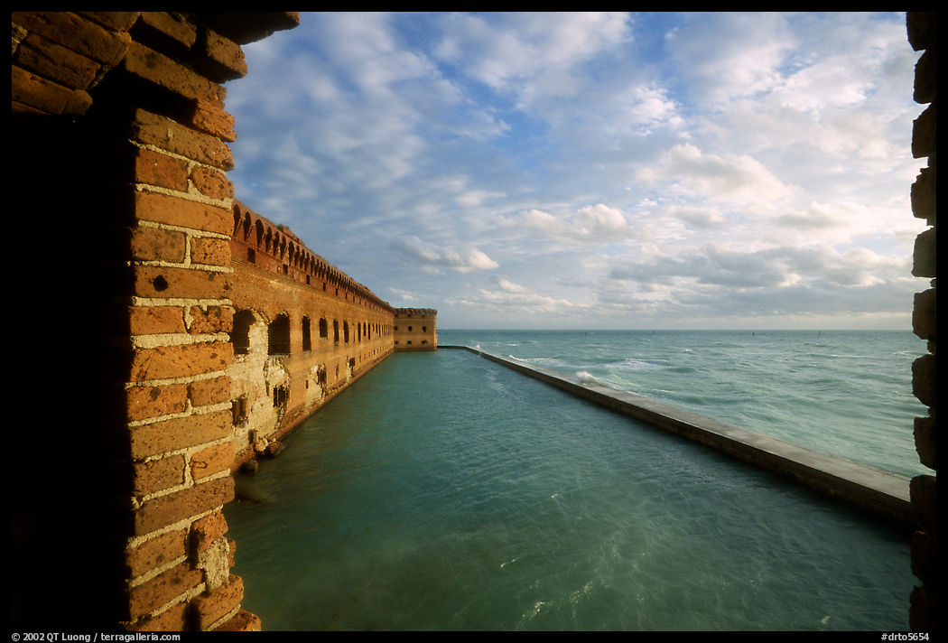 Fort Jefferson wall and moat, framed by cannon window. Dry Tortugas  National Park, Florida, USA.