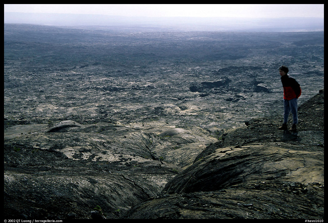 Hiker on top of Mauna Ulu crater. Hawaii Volcanoes National Park, Hawaii, USA.