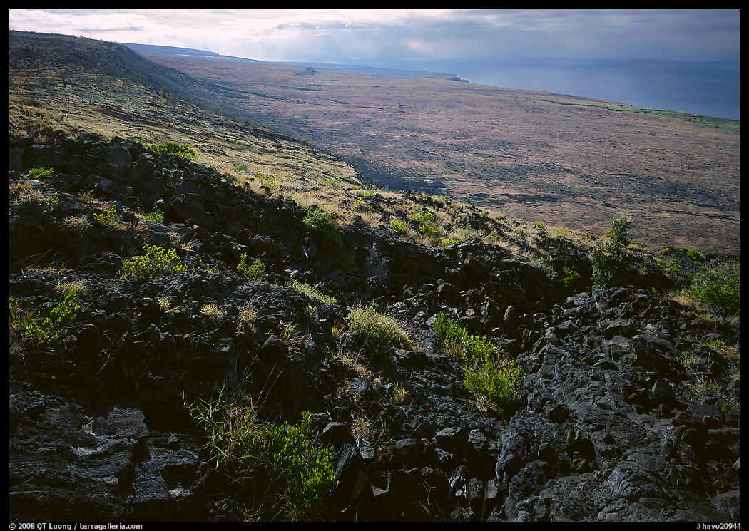 Black lava and coastal plain from Hilana Pali. Hawaii Volcanoes National Park, Hawaii, USA.