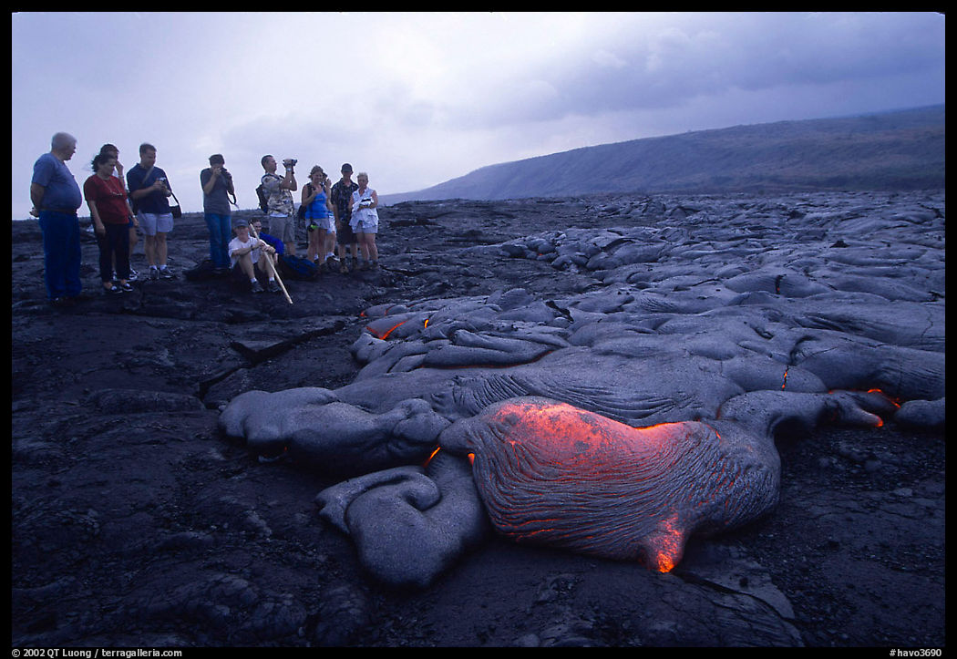 Visitors observe a live lava flow at close distance. Hawaii Volcanoes National Park