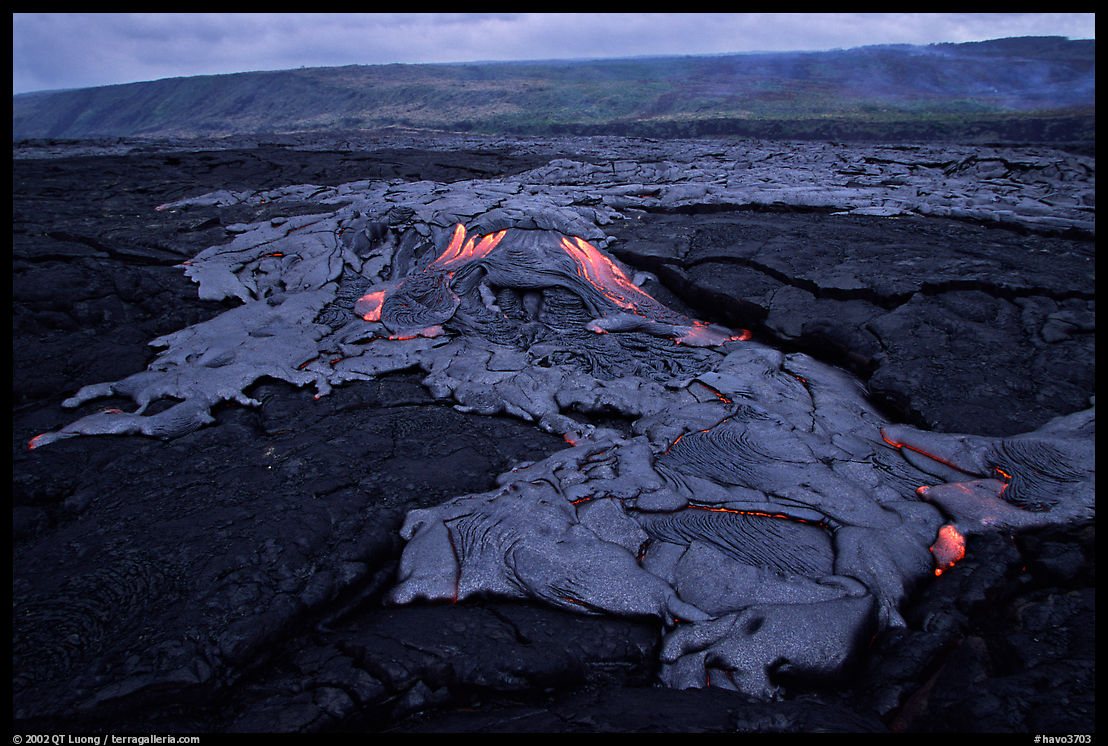 Live hot lava flows over hardened lava. Hawaii Volcanoes National Park, Hawaii, USA.