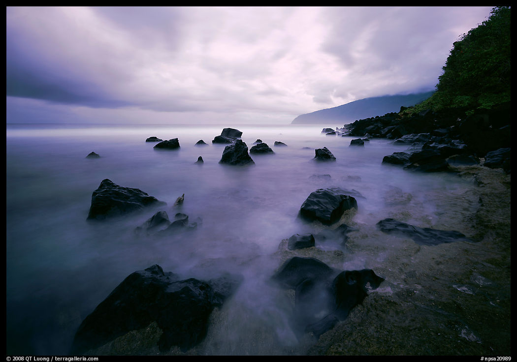 Seascape with smooth water, clouds and rocks, Siu Point, Tau Island. National Park of American Samoa