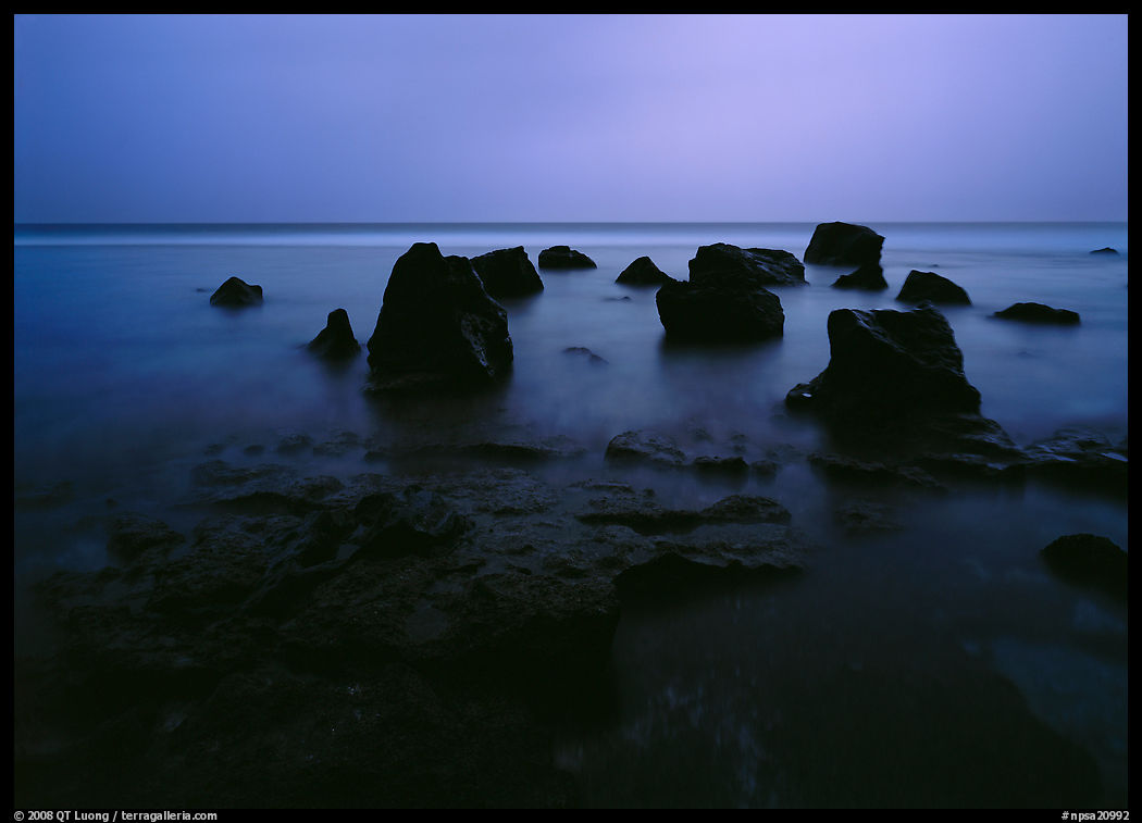 Rocks in water at dusk, Siu Point, Tau Island. National Park of American Samoa