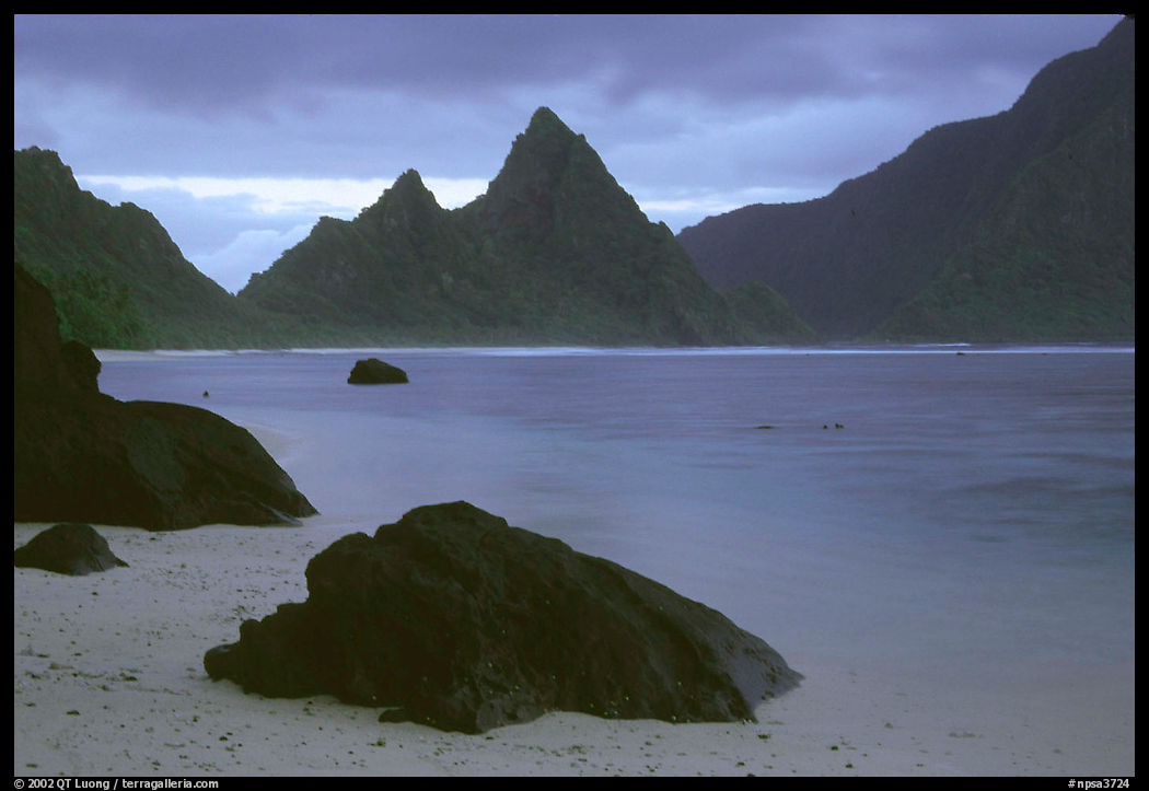 Balsalt boulders on South Beach, Sunuitao Peak in the background, Ofu Island. National Park of American Samoa
