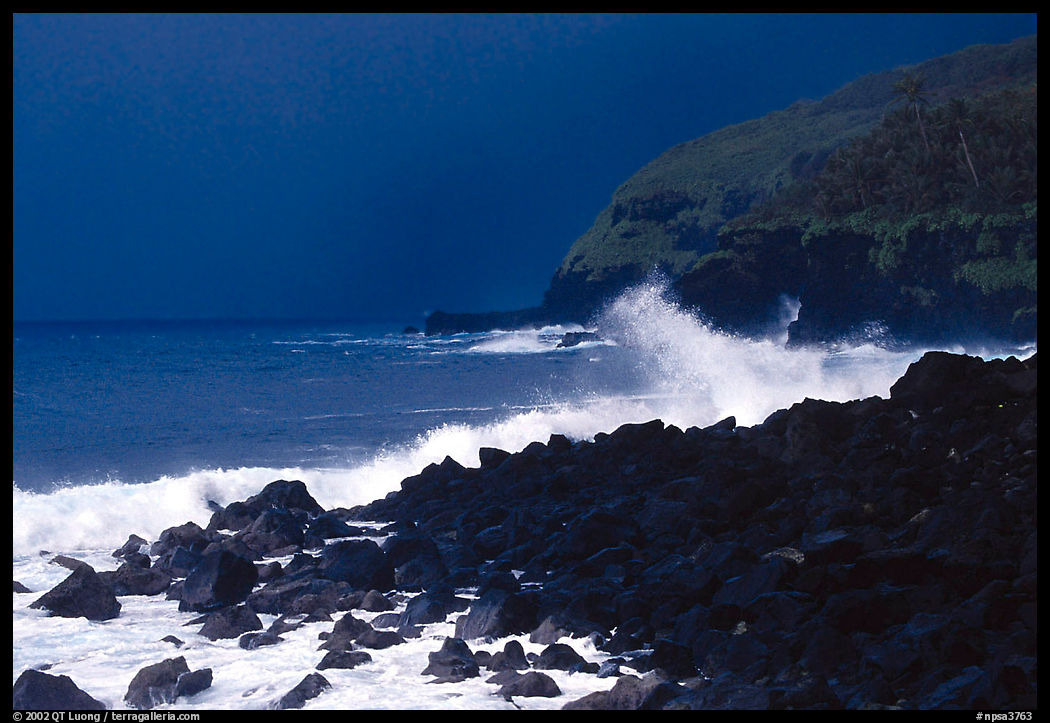 Dark boulders, crashing waves, and dark sky, storm light, Tau Island. National Park of American Samoa