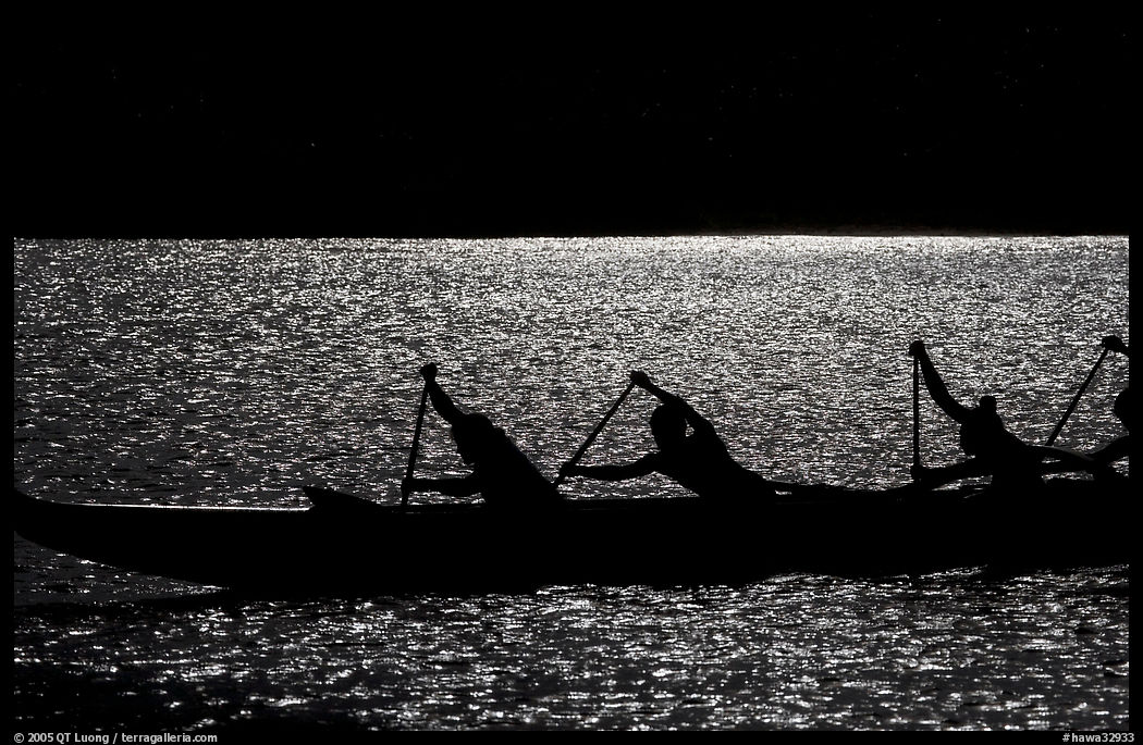 Backlit hawaiian canoe paddlers, Maunalua Bay, late afternoon. Oahu island, Hawaii, USA