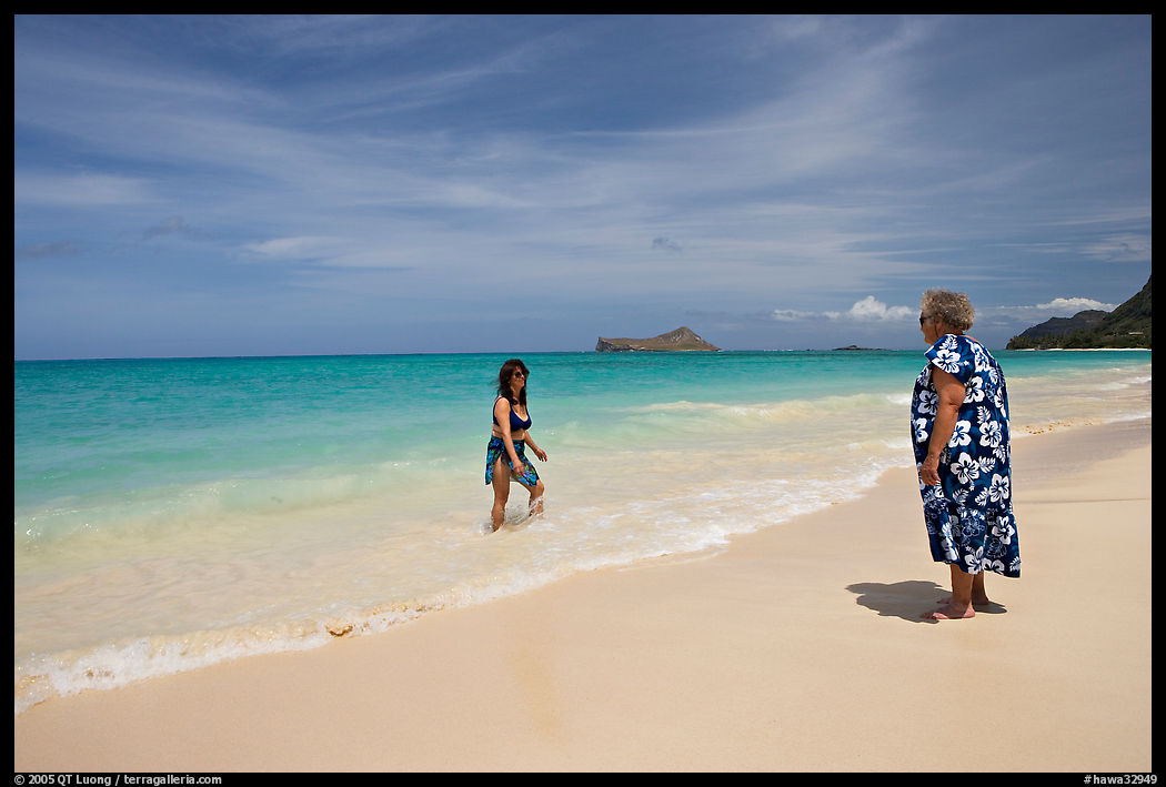 Two women, the Older in hawaiian dress, on Waimanalo Beach. Oahu island, Hawaii, USA