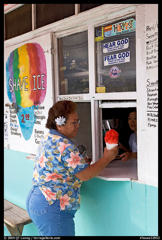 Woman with a flower in her hair getting shave ice, Waimanalo. Oahu island, Hawaii, USA