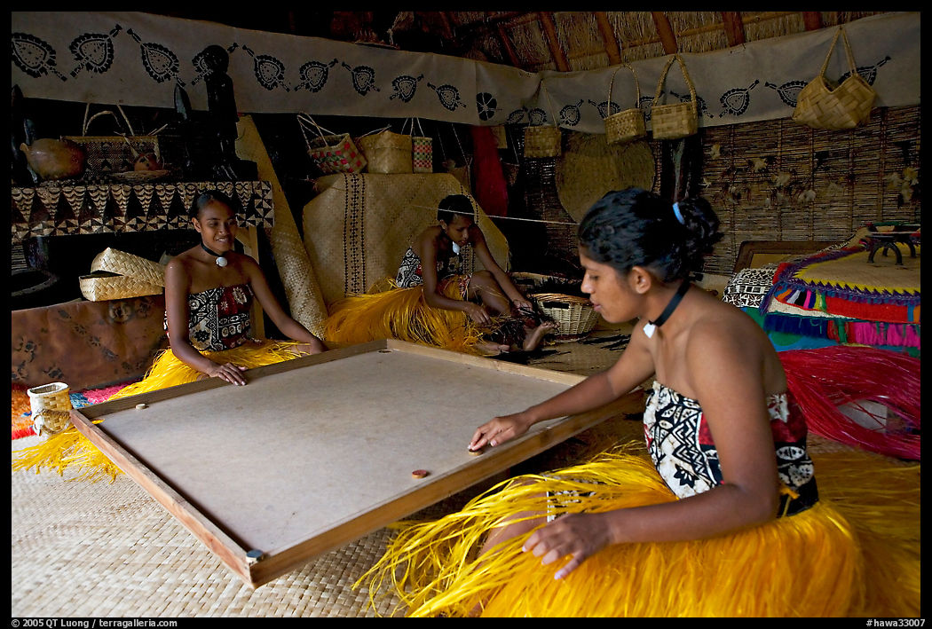 Fiji women playing at a traditional pool table in vale ni bose house. Polynesian Cultural Center, Oahu island, Hawaii, USA