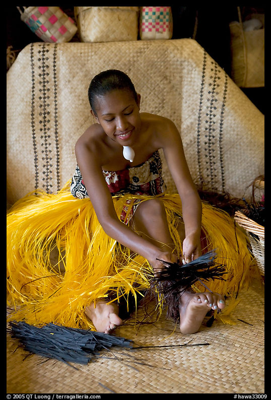 Fiji woman using her feet to tie leaves. Polynesian Cultural Center, Oahu island, Hawaii, USA