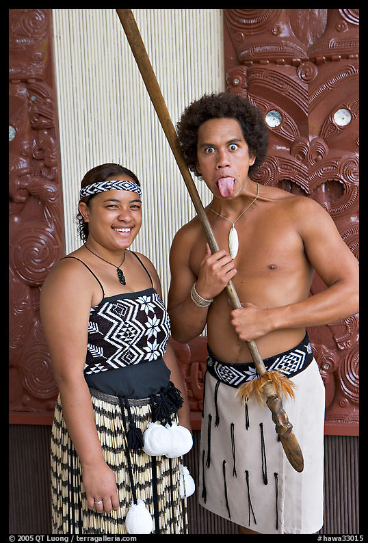 Maori woman and man sticking out his tongue. Polynesian Cultural Center, Oahu island, Hawaii, USA