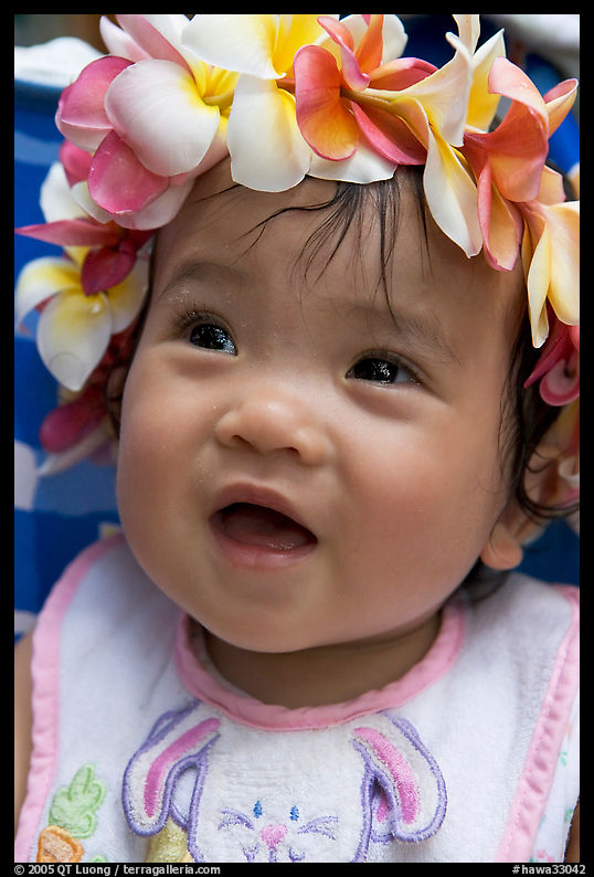 Baby girl wearing a flower lei on her head. Waikiki, Honolulu, Oahu island, Hawaii, USA