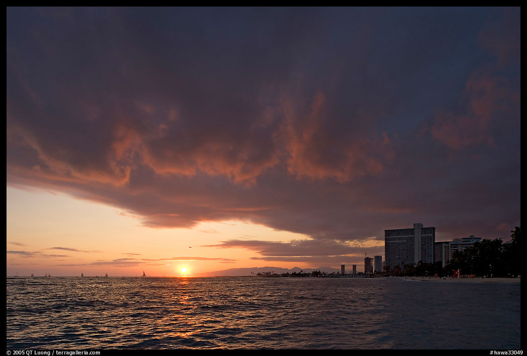 Sun setting and Honolulu skyline. Waikiki, Honolulu, Oahu island, Hawaii, USA