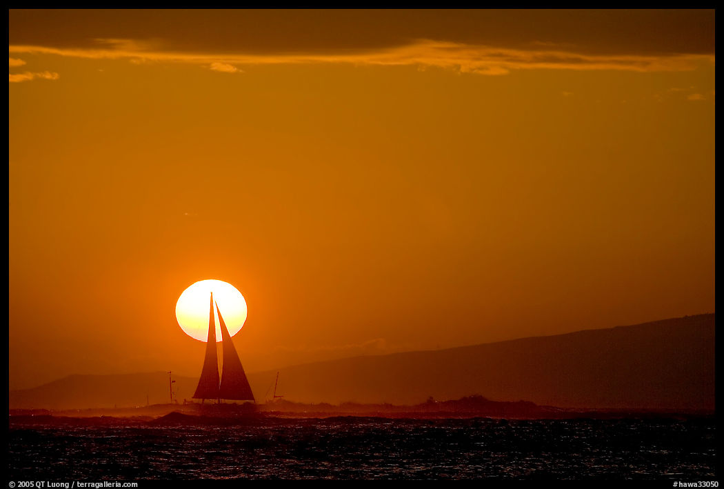 Sailboat and sun disk, sunset. Waikiki, Honolulu, Oahu island, Hawaii, USA