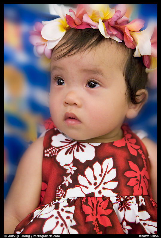 Baby girl in hawaiian dress wearing a flower lei on her head. Waikiki, Honolulu, Oahu island, Hawaii, USA