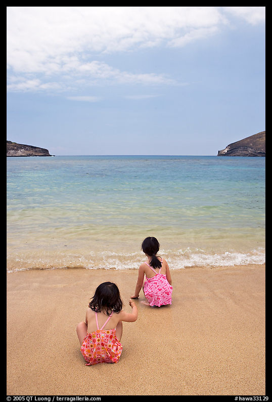 Two girls at the edge of water, Hanauma Bay. Oahu island, Hawaii, USA