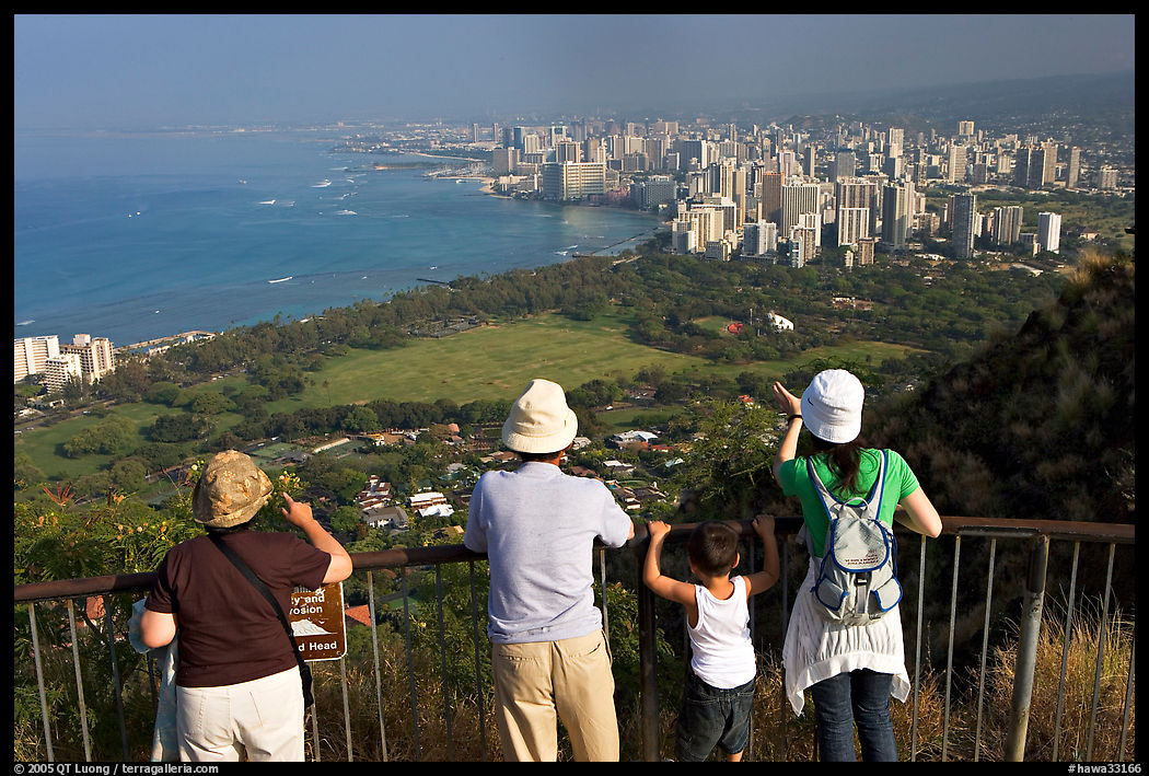 Visitors look at Waikidi from the  Diamond Head crater, early morning. Oahu island, Hawaii, USA
