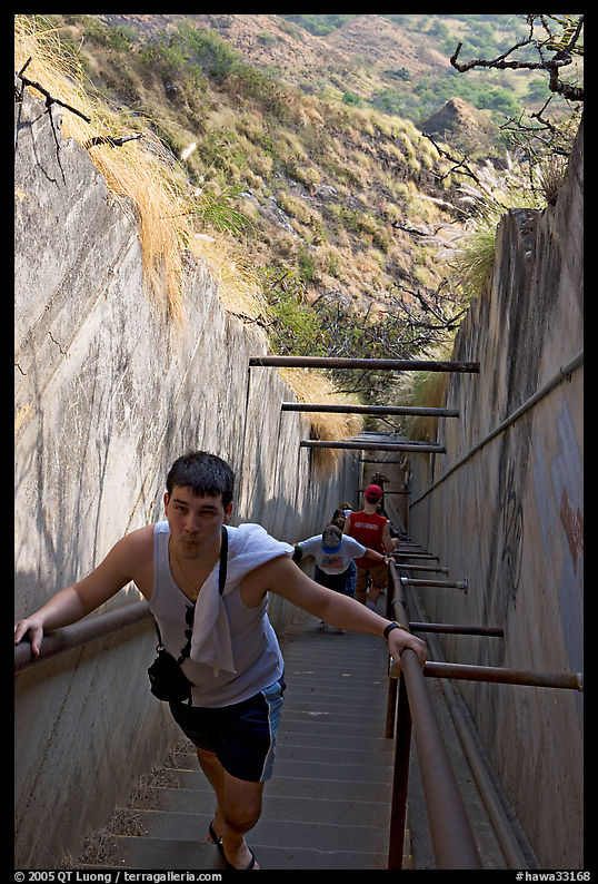 Visitor climbing a staircase on the Diamond Head summit trail. Oahu island, Hawaii, USA