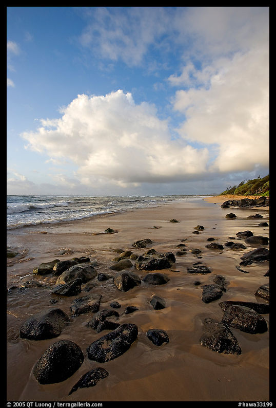 Boulders, coastline, and clouds, Lydgate Park, sunrise. Kauai island, Hawaii, USA
