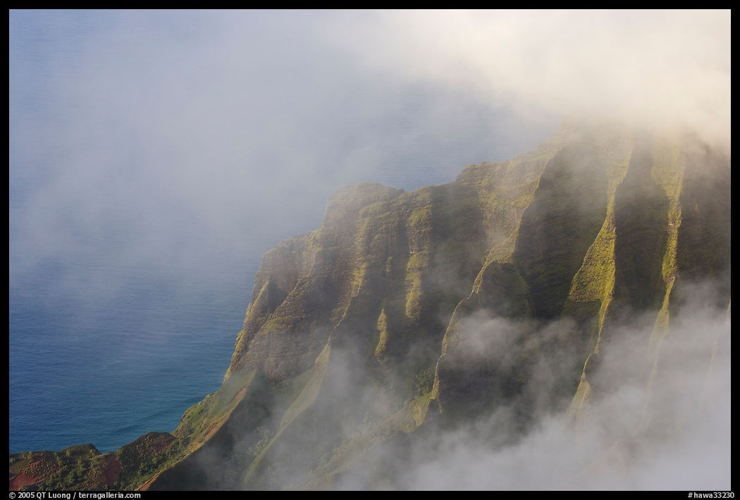 Fluted ridges seen through clouds, Kalalau lookout, late afternoon. Kauai island, Hawaii, USA