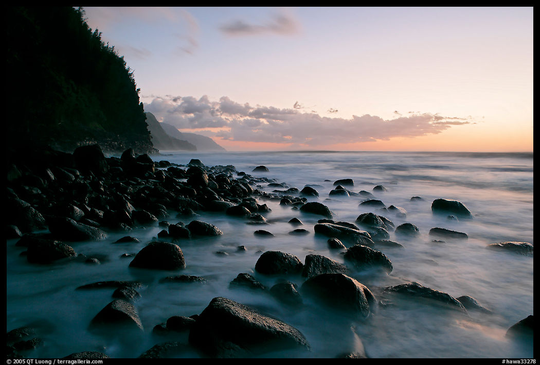 Boulders, surf, and Na Pali Coast, Kee Beach, dusk. Kauai island, Hawaii, USA