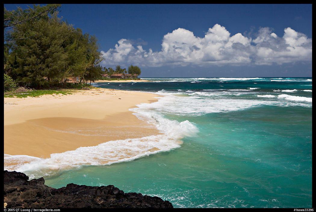 Beach and  turquoise waters, and homes  near Haena. North shore, Kauai island, Hawaii, USA