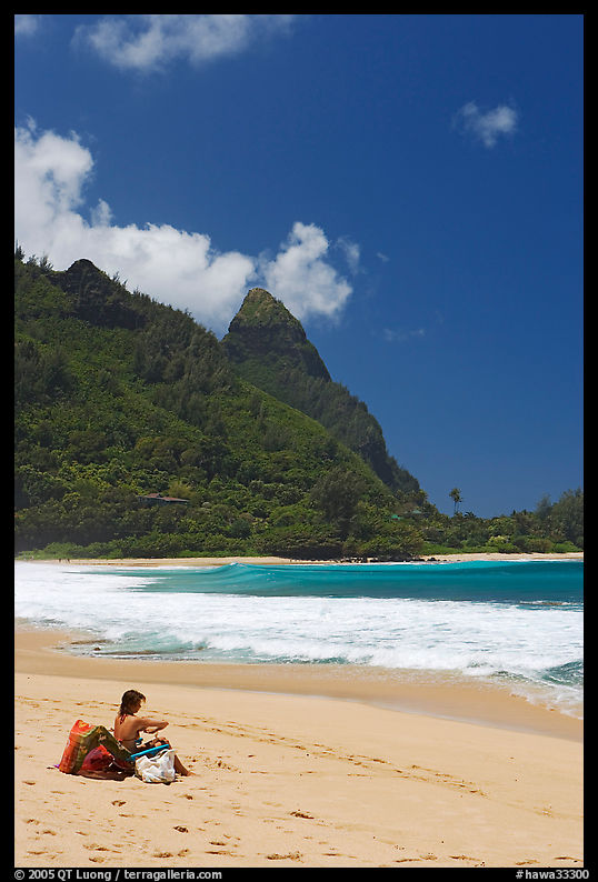 Woman sitting on a beach chair on Tunnels Beach. North shore, Kauai island, Hawaii, USA