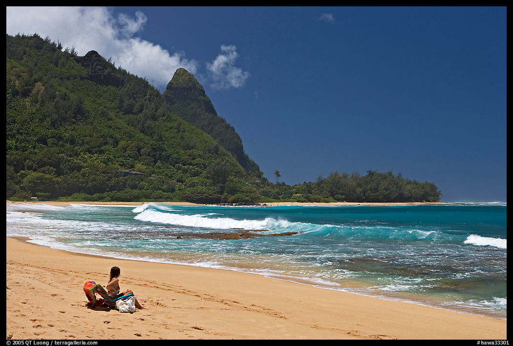 Woman sitting on a beach chair on Makua (Tunnels) Beach. North shore, Kauai island, Hawaii, USA
