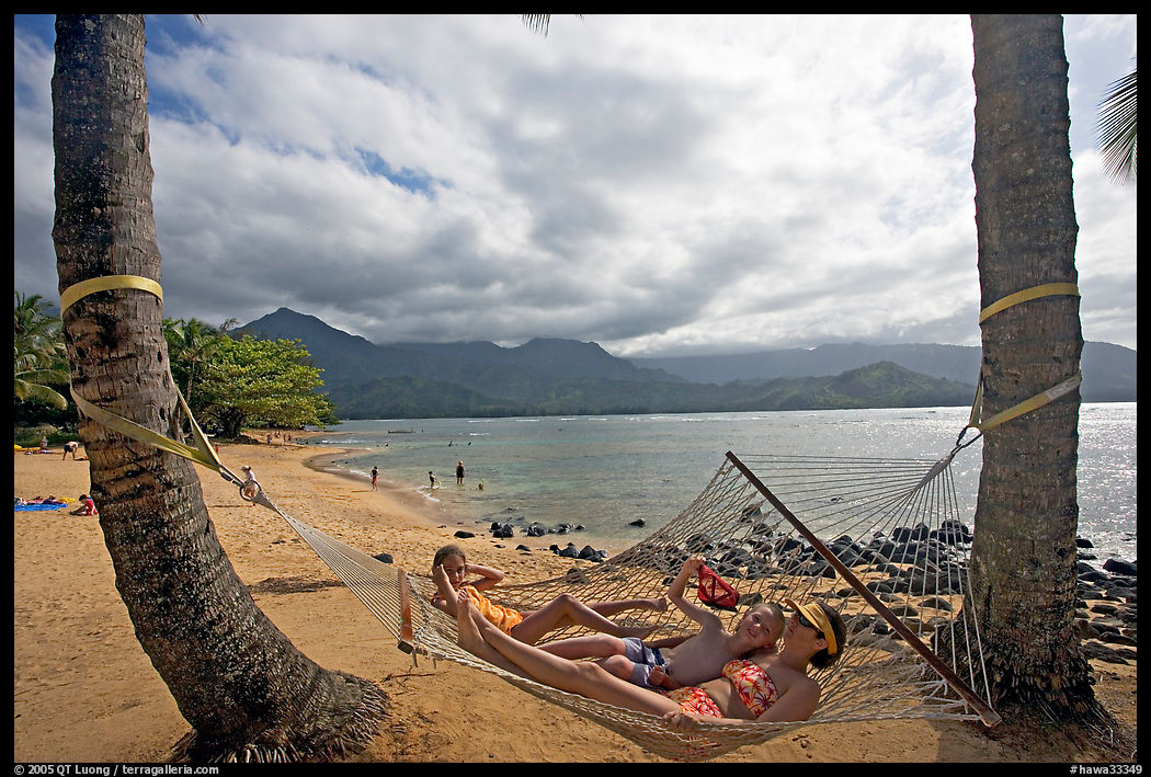 Family on Hammock with Hanalei Bay in the background. North shore, Kauai island, Hawaii, USA