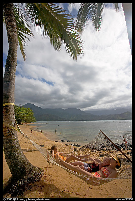 Family on Hammock, Puu Poa Beach. North shore, Kauai island, Hawaii, USA