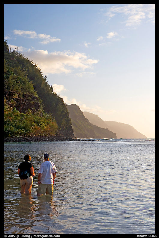Couple looking at the Na Pali Coast, Kee Beach, late afternoon. Kauai island, Hawaii, USA