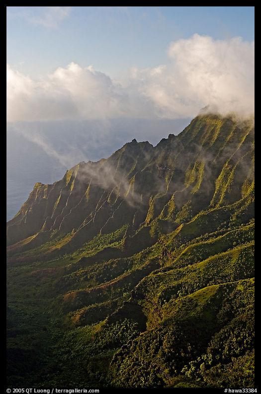 Lush Hills above Kalalau Valley and clouds, late afternoon. Kauai island, Hawaii, USA