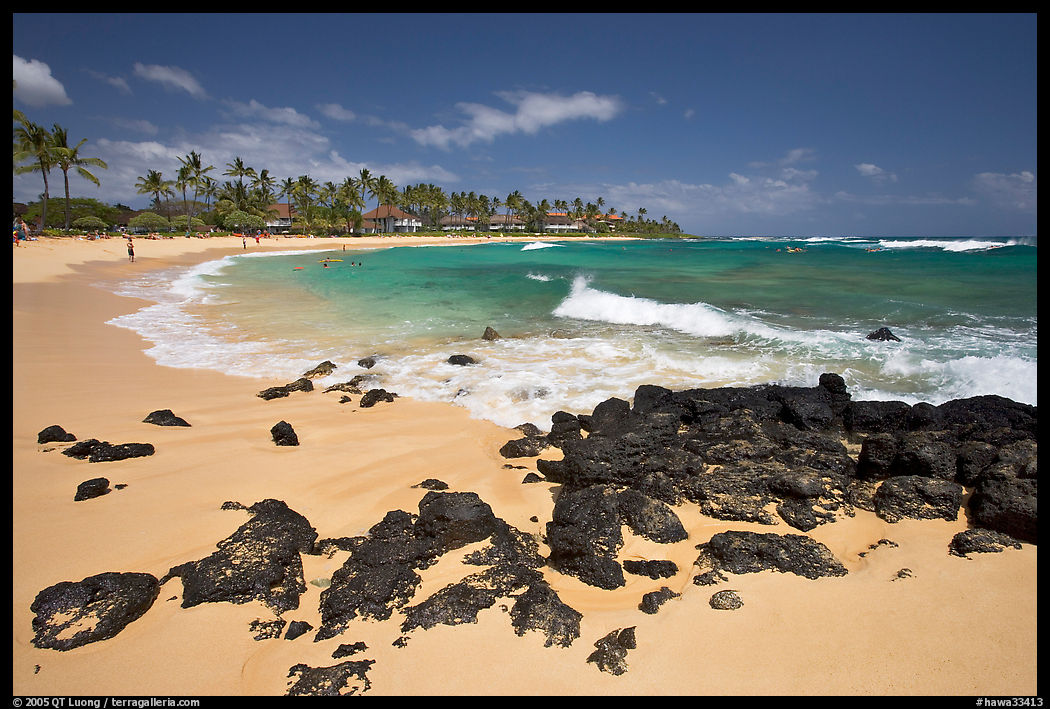 Dark rocks and Kiahuna Beach, mid-day. Kauai island, Hawaii, USA