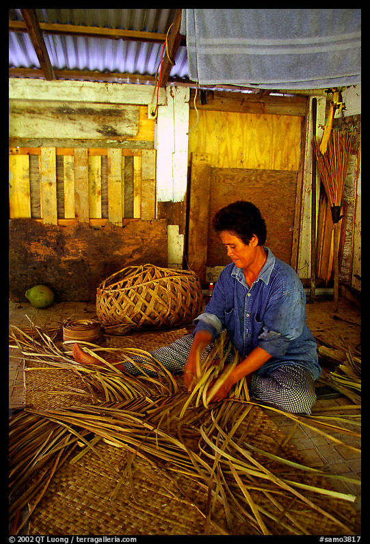 Woman weaving a toga (mat) out of pandamus leaves. American Samoa