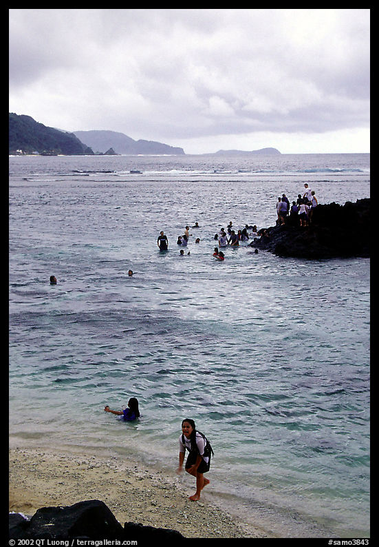 Children playing in water near Fugaalu. Pago Pago, Tutuila, American Samoa