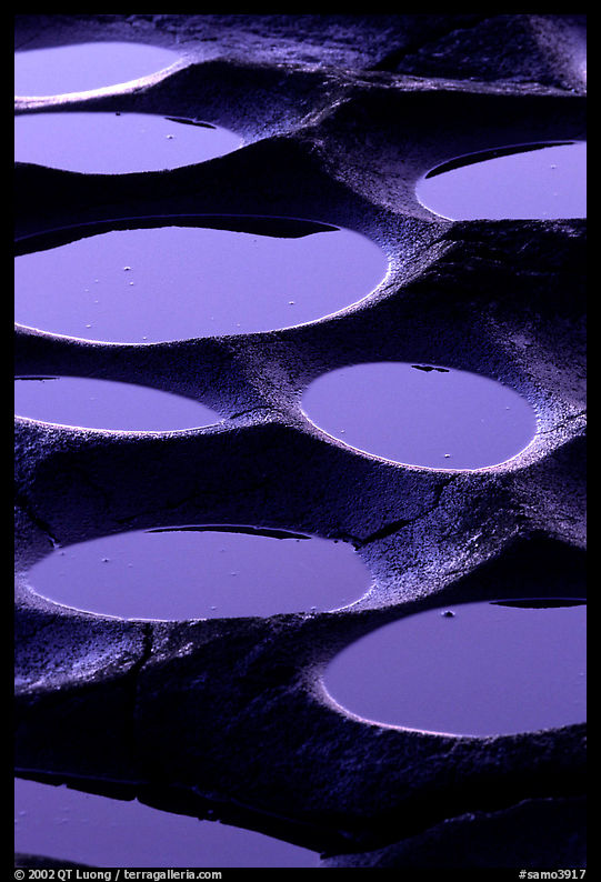 Water-filled  grinding stones holes (foaga) near Leone at sunset. Tutuila, American Samoa