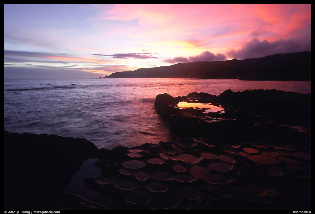 Ancient grinding stones (foaga) and Leone Bay at sunset. Tutuila, American Samoa