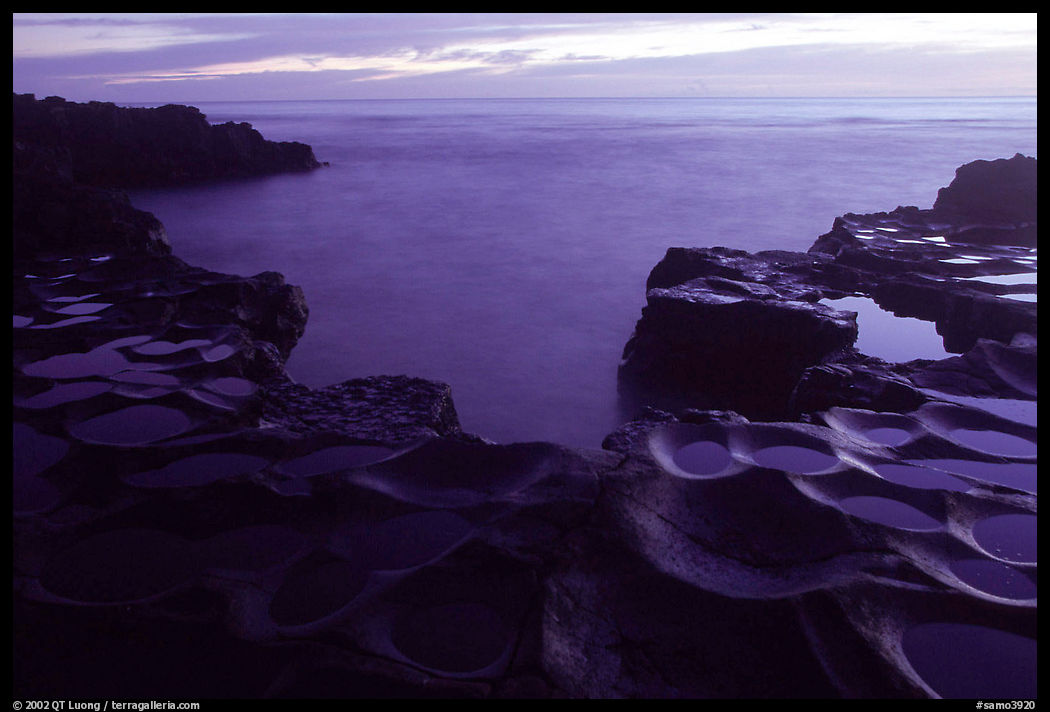 Ancient grinding stones (foaga) and Leone Bay at dusk. Tutuila, American Samoa