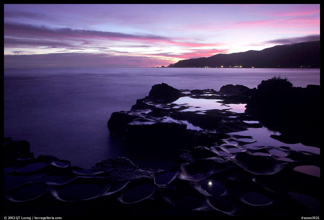 Grinding stones holes (foaga) filled with water at dusk, Leone Bay. Tutuila, American Samoa
